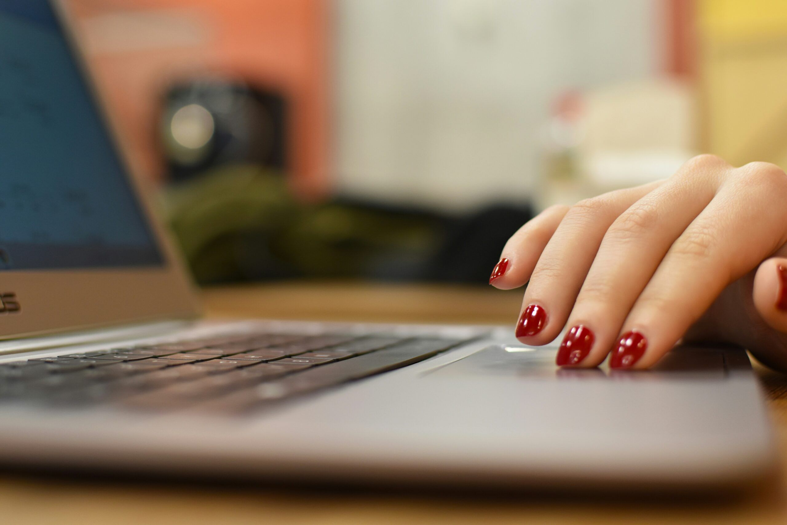 Close-up of a hand using a laptop, symbolizing the importance of accessibility audits for digital inclusivity.